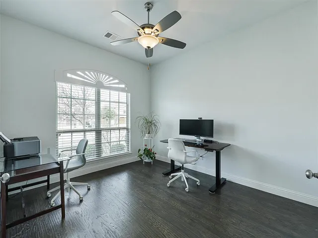 a workspace with wooden floor and a window