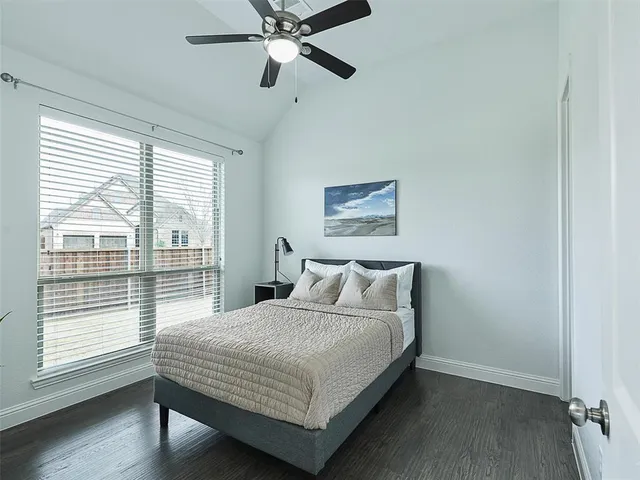 a bedroom with a bed and a large window