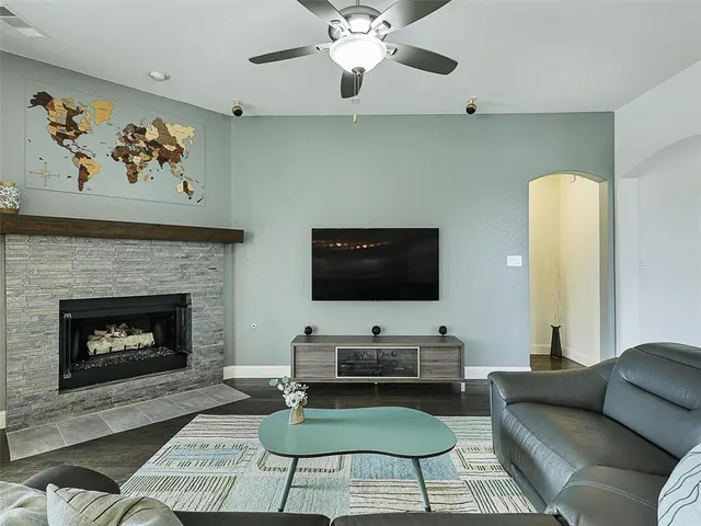 a living room with furniture a fireplace and a flat screen tv