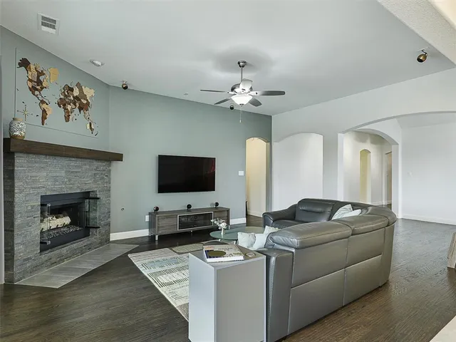 a living room with furniture a fireplace and a flat screen tv