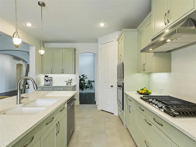 a kitchen with a sink stove and refrigerator