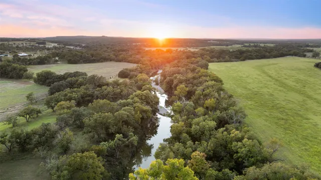 a kitchen with cabinets wooden floor and stainless steel appliances
