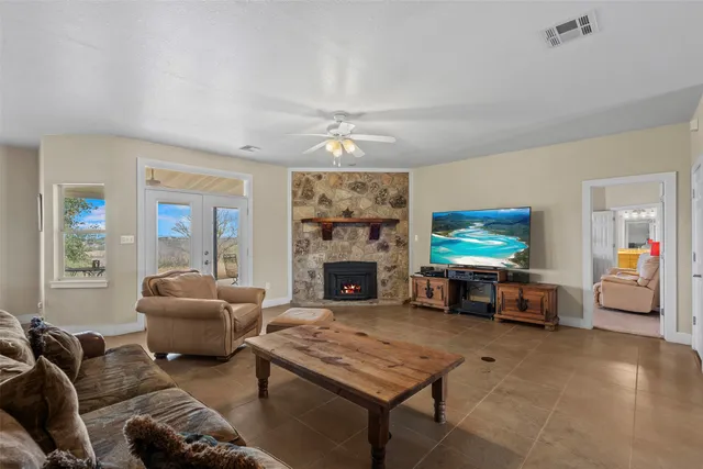 a bedroom with a bed and large windows