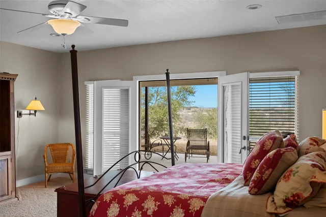a bedroom with a bed furniture chandelier and a window