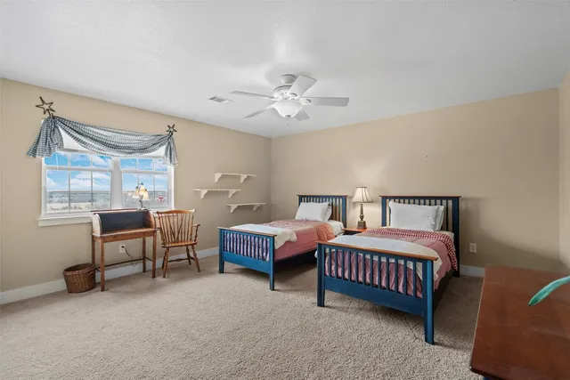 a bedroom with bed couch and window