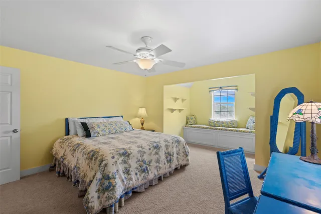 a spacious bathroom with a granite countertop tub a double vanity sink a two mirror a window and a bathtub