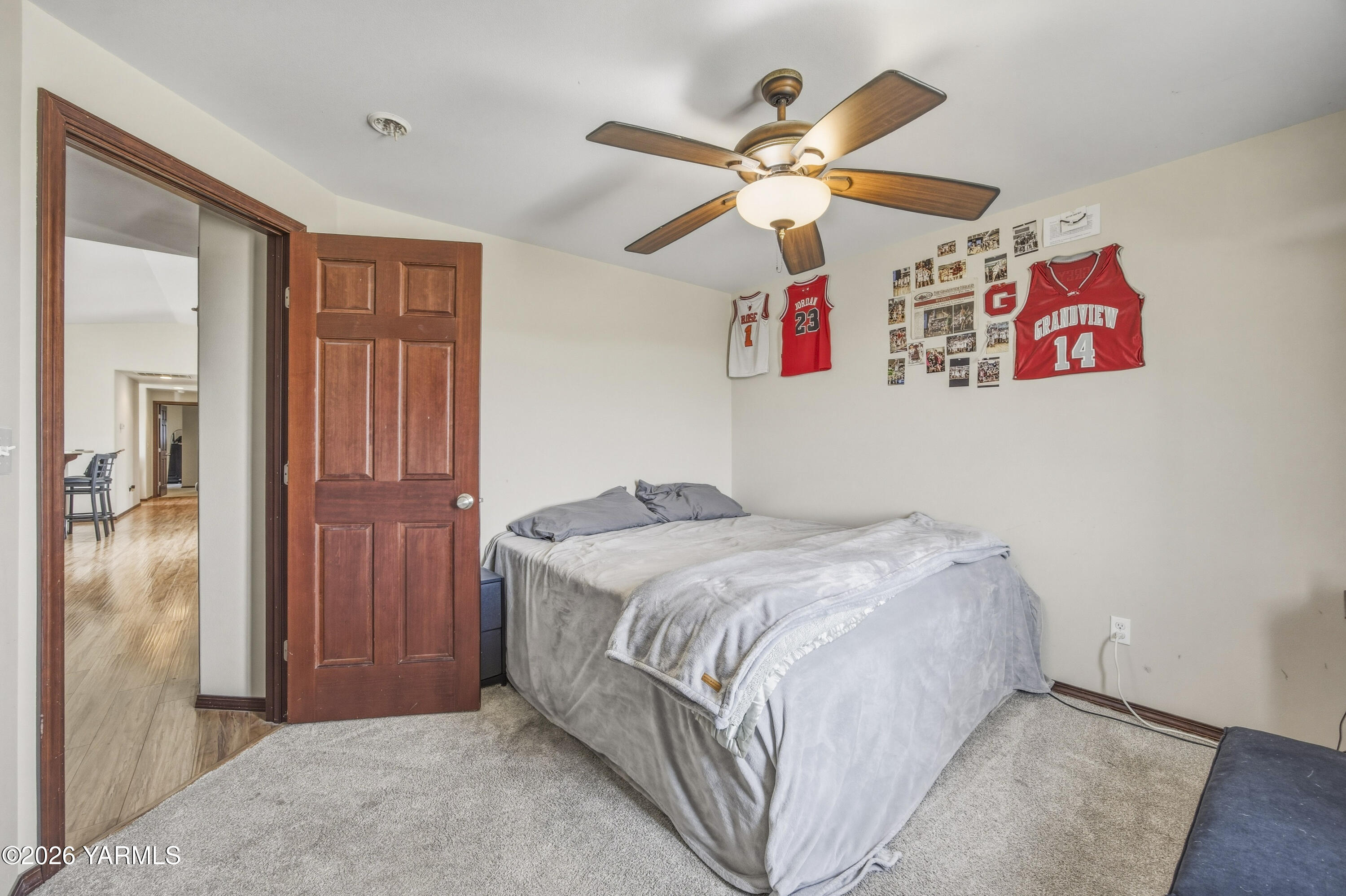 2050 Olmstead Road Grandview, WA 98930 - Photo 46 of 60 a bedroom with a bed and a chandelier