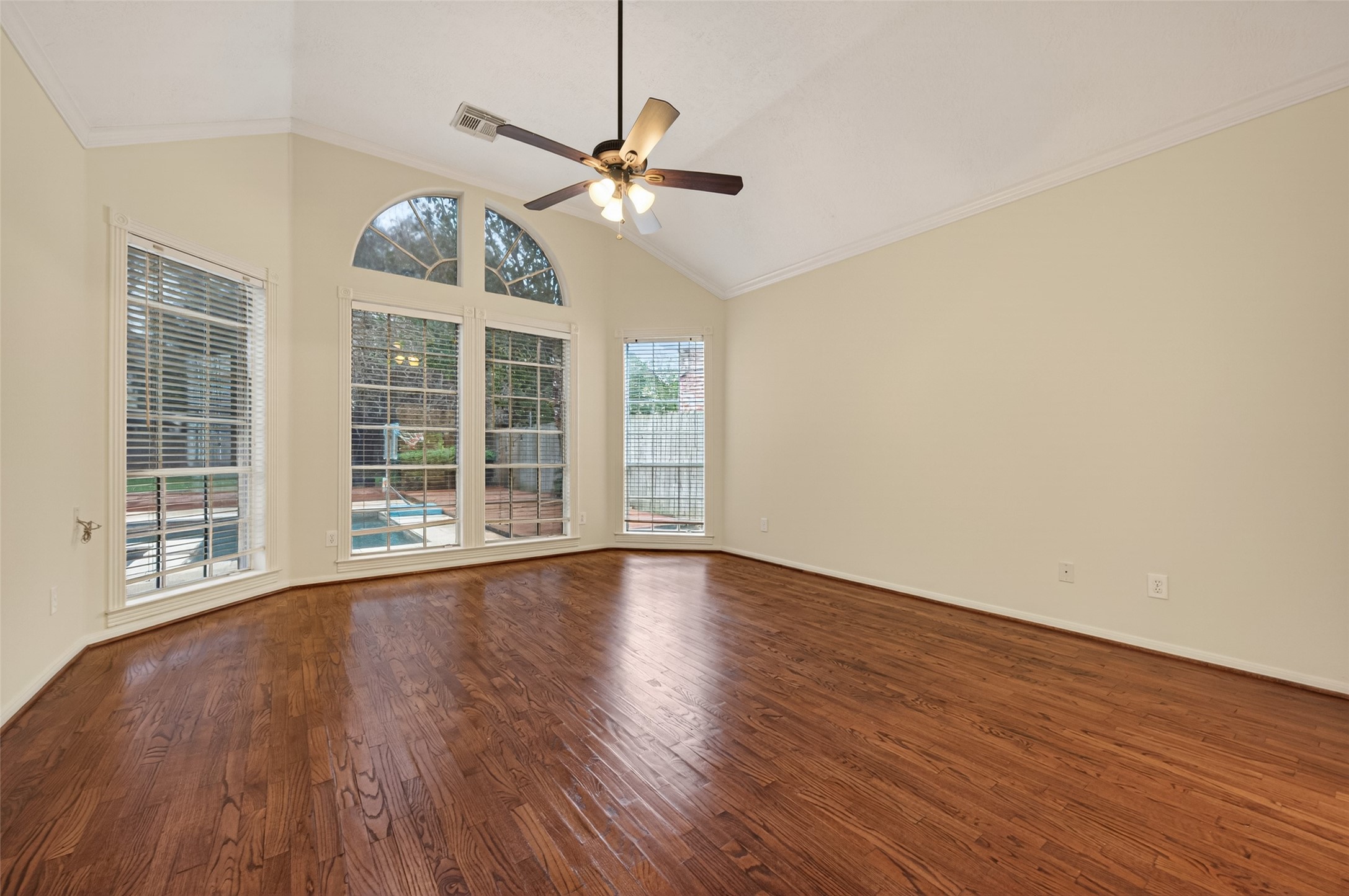 2115 Foreland Drive Houston, TX 77077 - Photo 22 of 50 Downstairs primary bedroom with wood flooring and windows overlooking the back yard