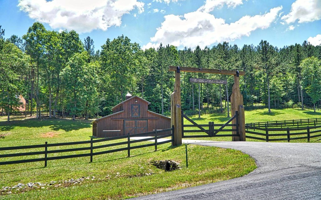 Lot 70 Ridge Peak View Blairsville, GA 30512 - Photo 5 of 12 a wooden bench sitting in front of a house