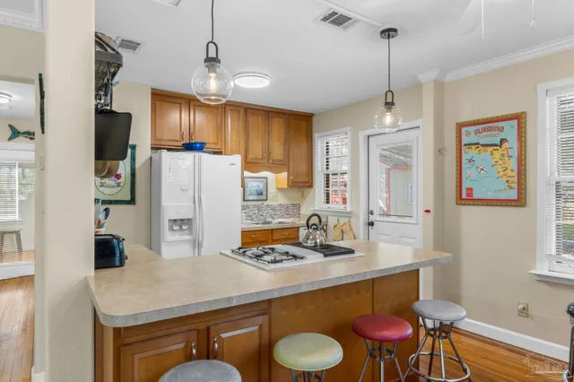 a kitchen with stainless steel appliances a sink a table and chairs