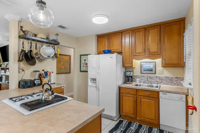 a kitchen with sink refrigerator and stove