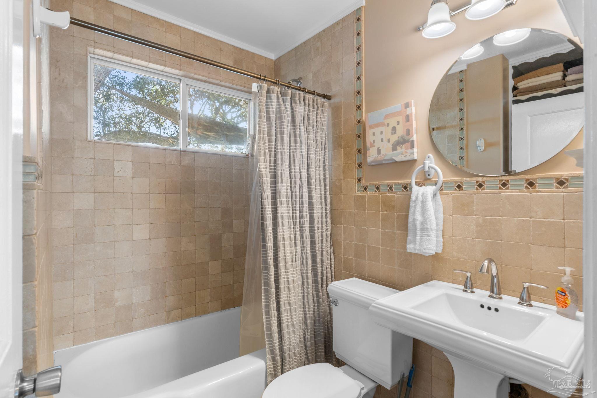 112 Cousineau Road Pensacola, FL 32507 - Photo 18 of 54 a bathroom with a sink a toilet and a mirror