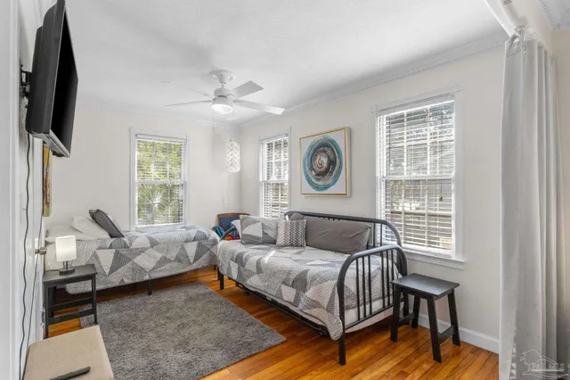 a living room with a bed furniture and a window