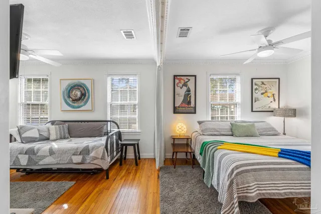 a bedroom with a bed a couch and dresser