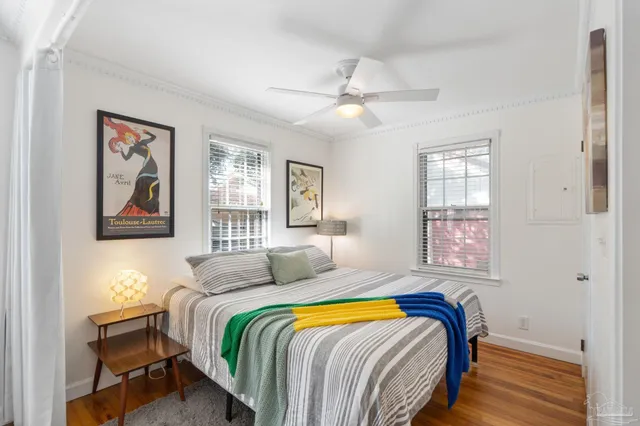 a bedroom with a bed couch and window