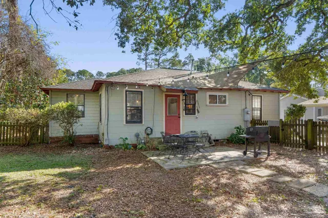 a view of a yard with a house and a tree