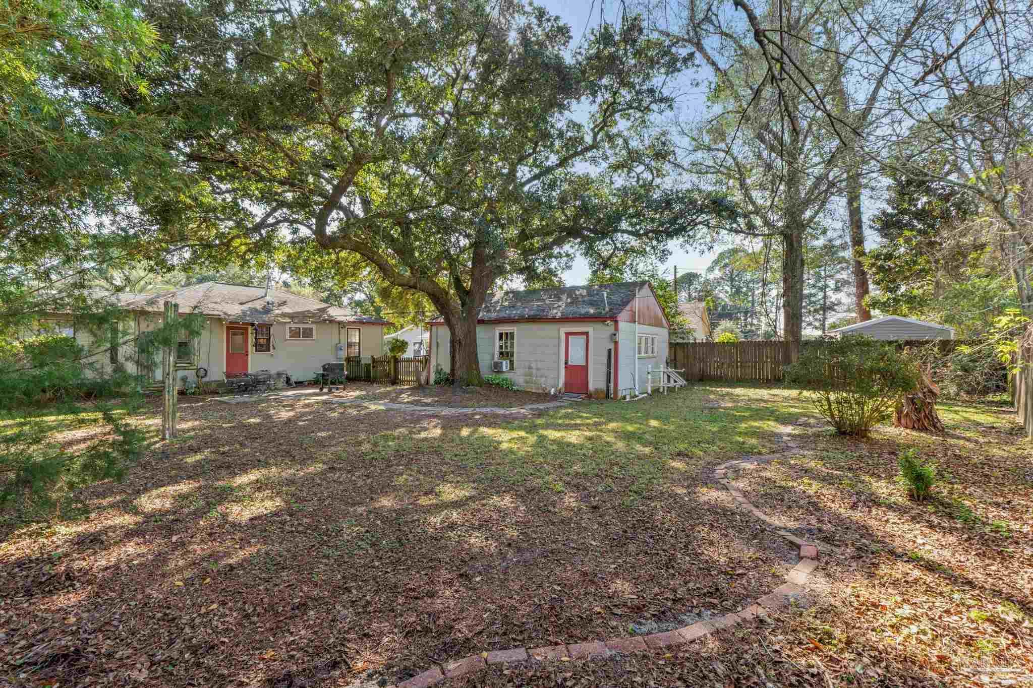 112 Cousineau Road Pensacola, FL 32507 - Photo 31 of 54 a view of a yard with a house and a tree