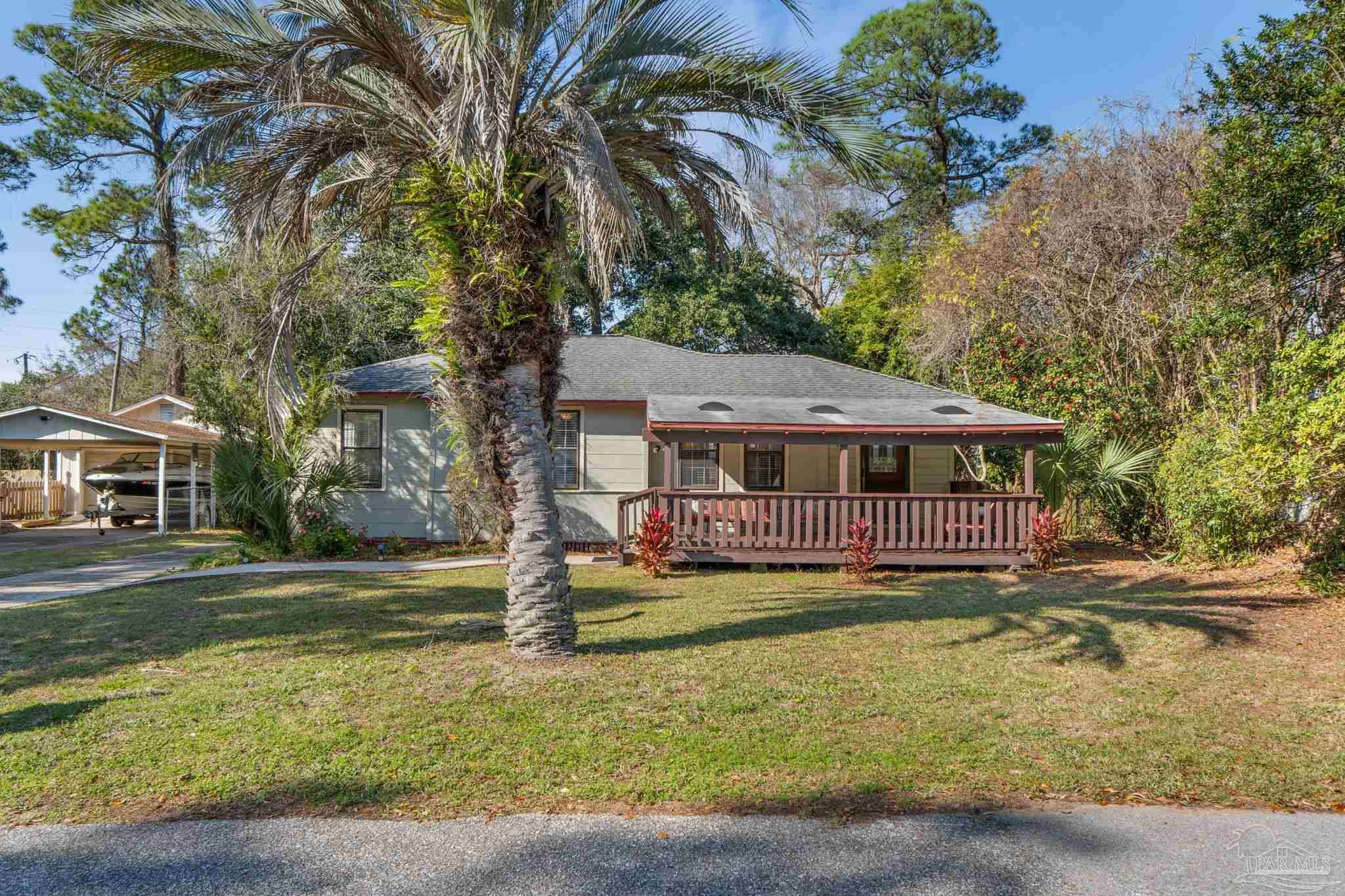 112 Cousineau Road Pensacola, FL 32507 - Photo 38 of 54 a front view of a house with a yard table and chairs
