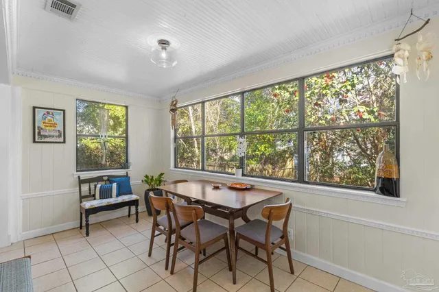 a dining room with furniture and a large window