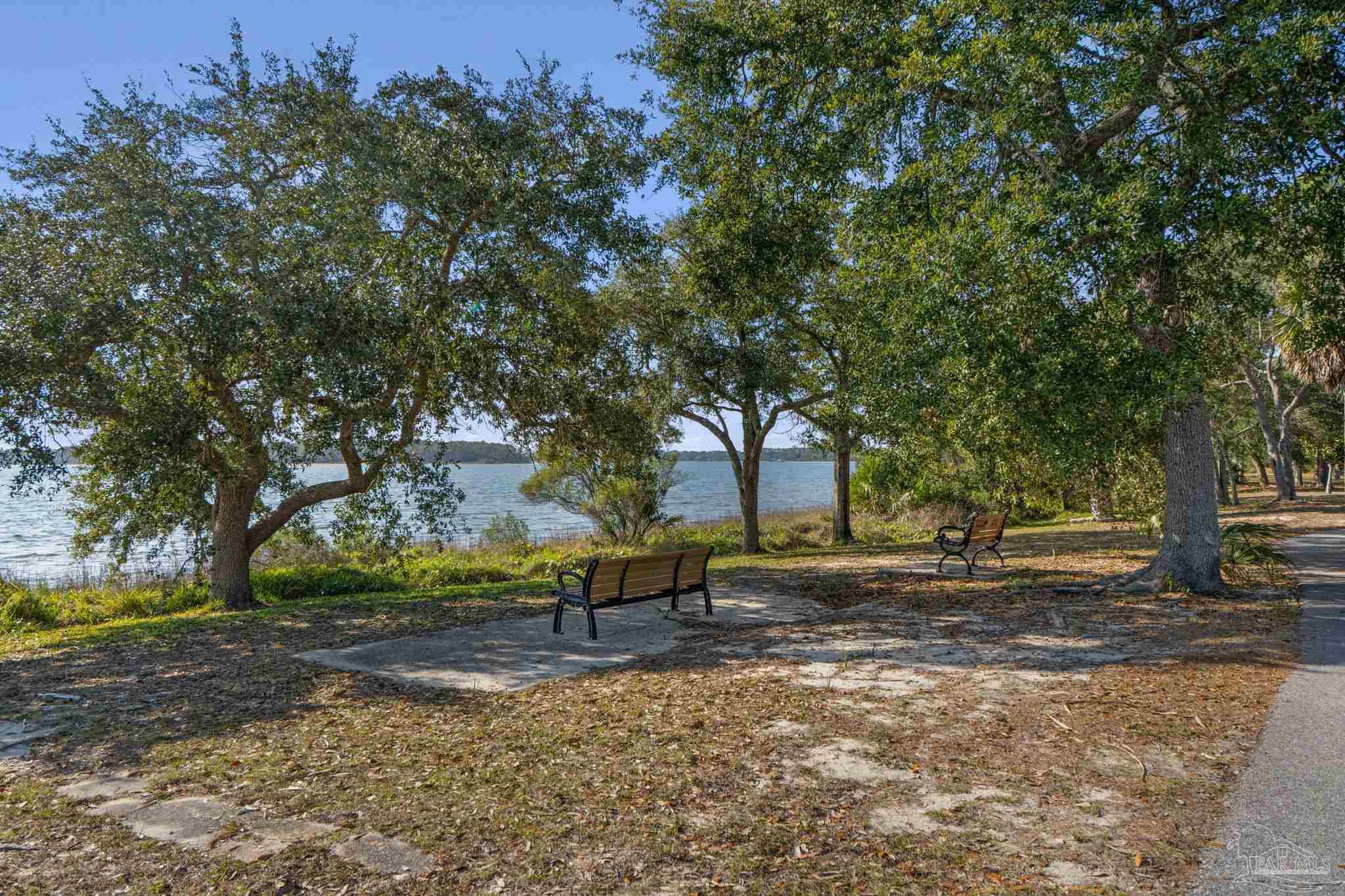 112 Cousineau Road Pensacola, FL 32507 - Photo 42 of 54 a backyard of a house with trees and outdoor seating