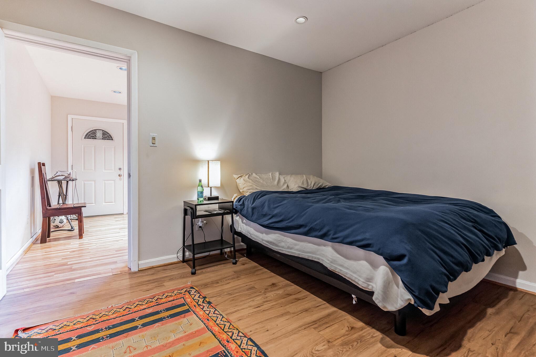 9329 Harvey Road Silver Spring, MD 20910 - Photo 28 of 40 a bedroom with a bed and wooden floor