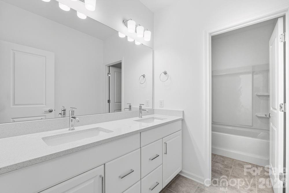 3159 Beacon Hts Road Indian Land, SC 29707 - Photo 12 of 33 a bathroom with a sink double vanity granite tub and shower
