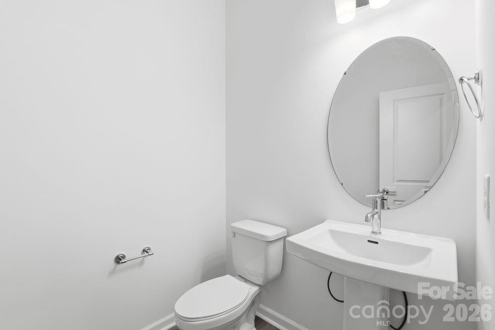 3159 Beacon Hts Road Indian Land, SC 29707 - Photo 13 of 33 a bathroom with a sink a mirror and a toilet