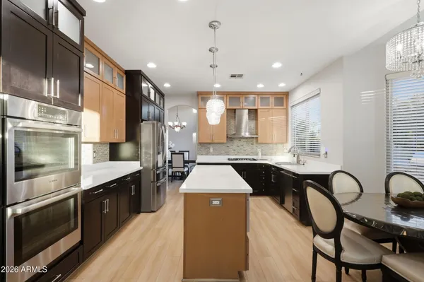 a kitchen with a refrigerator a sink and cabinets