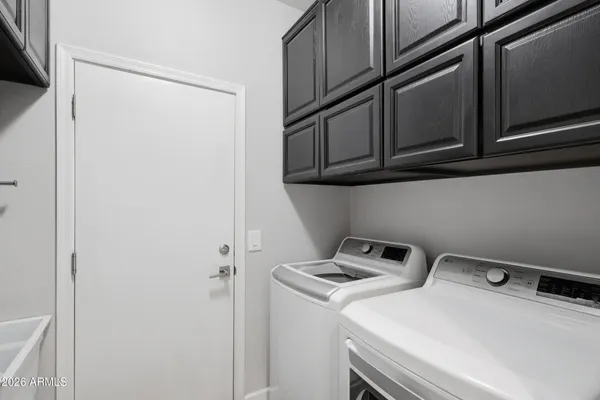 a bedroom with a bed a couch and window