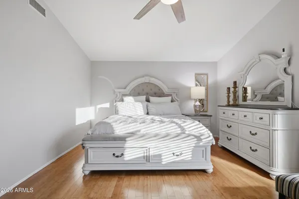 a spacious bathroom with a granite countertop sink a mirror and shower