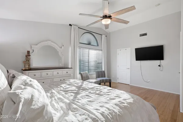 a bedroom with a bed and a chandelier