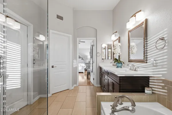 a bathroom with a double vanity sink toilet and a mirror