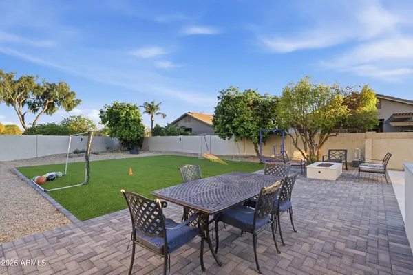 an outdoor space with furniture and garden