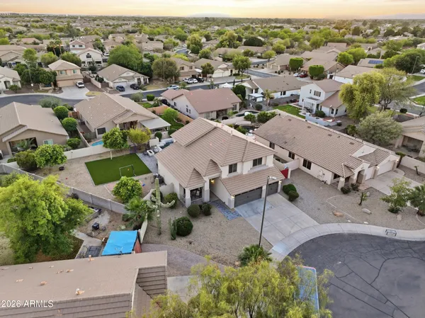 an aerial view of a house with a yard