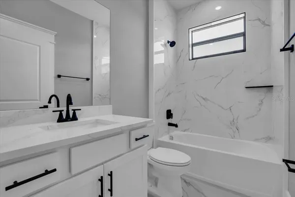 a bathroom with a sink a toilet and a bathtub