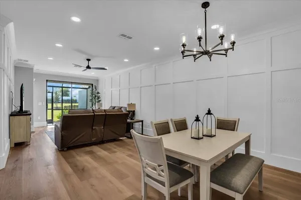 a kitchen with a table chairs and refrigerator