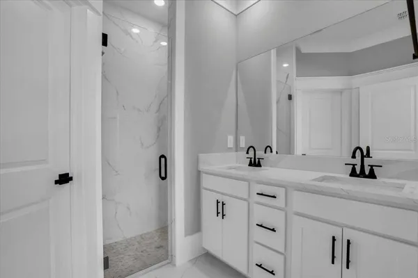 a bathroom with a double vanity sink and mirror