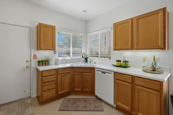 a kitchen with a sink cabinets and window
