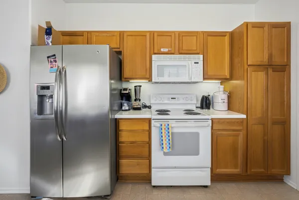 a kitchen with stainless steel appliances a refrigerator and a stove