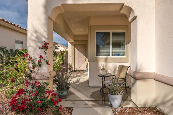 a view of a patio with table and chairs and potted plants