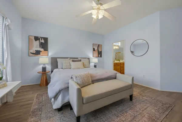 a bedroom with a bed and a chandelier