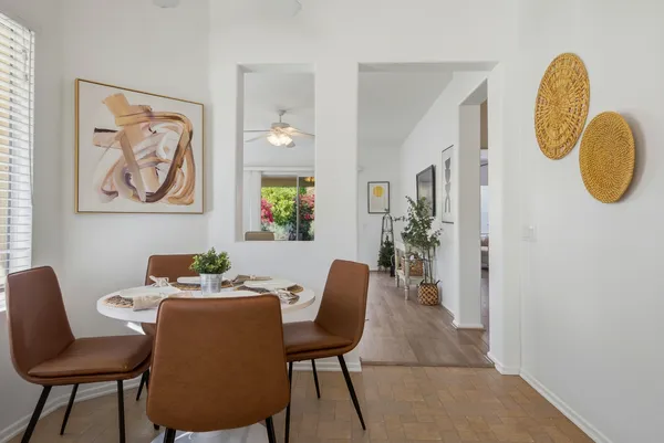 a dining room with furniture and wooden floor