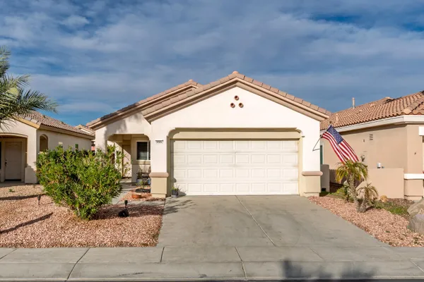 a front view of a house with a yard and garage