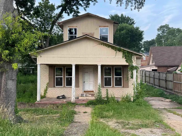 a front view of a house with a yard and porch