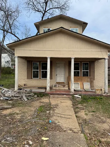 a house that has a big yard and large trees
