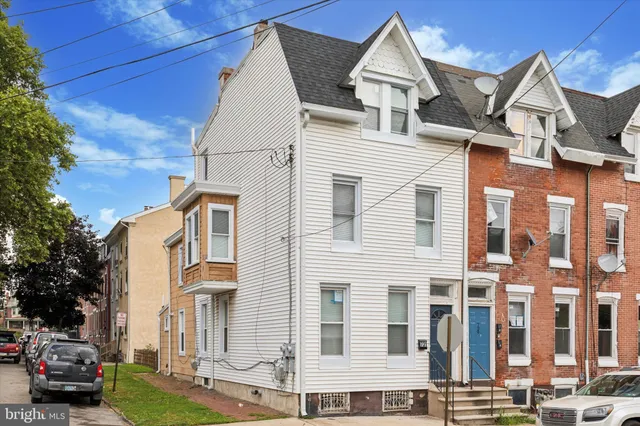 a front view of a residential apartment building with a yard