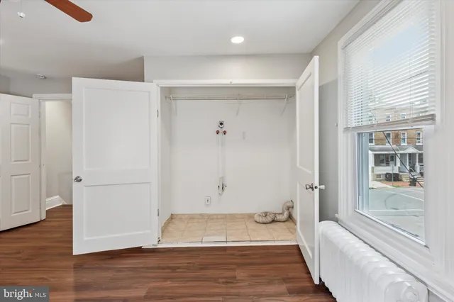 a view of room with window and wooden floor