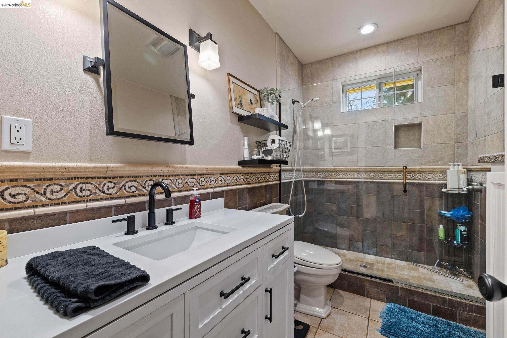 10177 Pulpit Rock Road Jamestown, CA 95327 - Photo 17 of 60 Bathroom featuring vanity, tiled shower, tile walls, light tile patterned floors, and recessed lighting