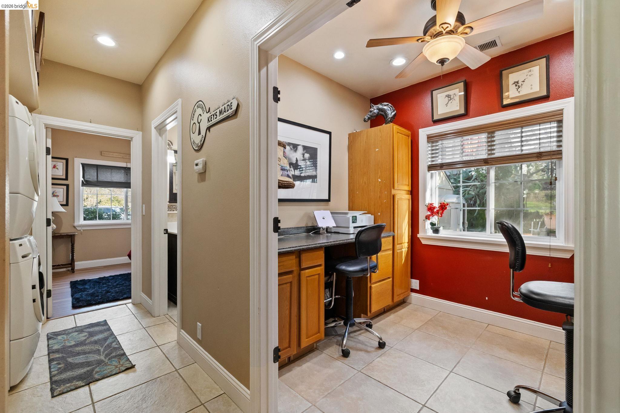 10177 Pulpit Rock Road Jamestown, CA 95327 - Photo 22 of 60 Office area featuring stacked washer / dryer, light tile patterned floors, and ceiling fan