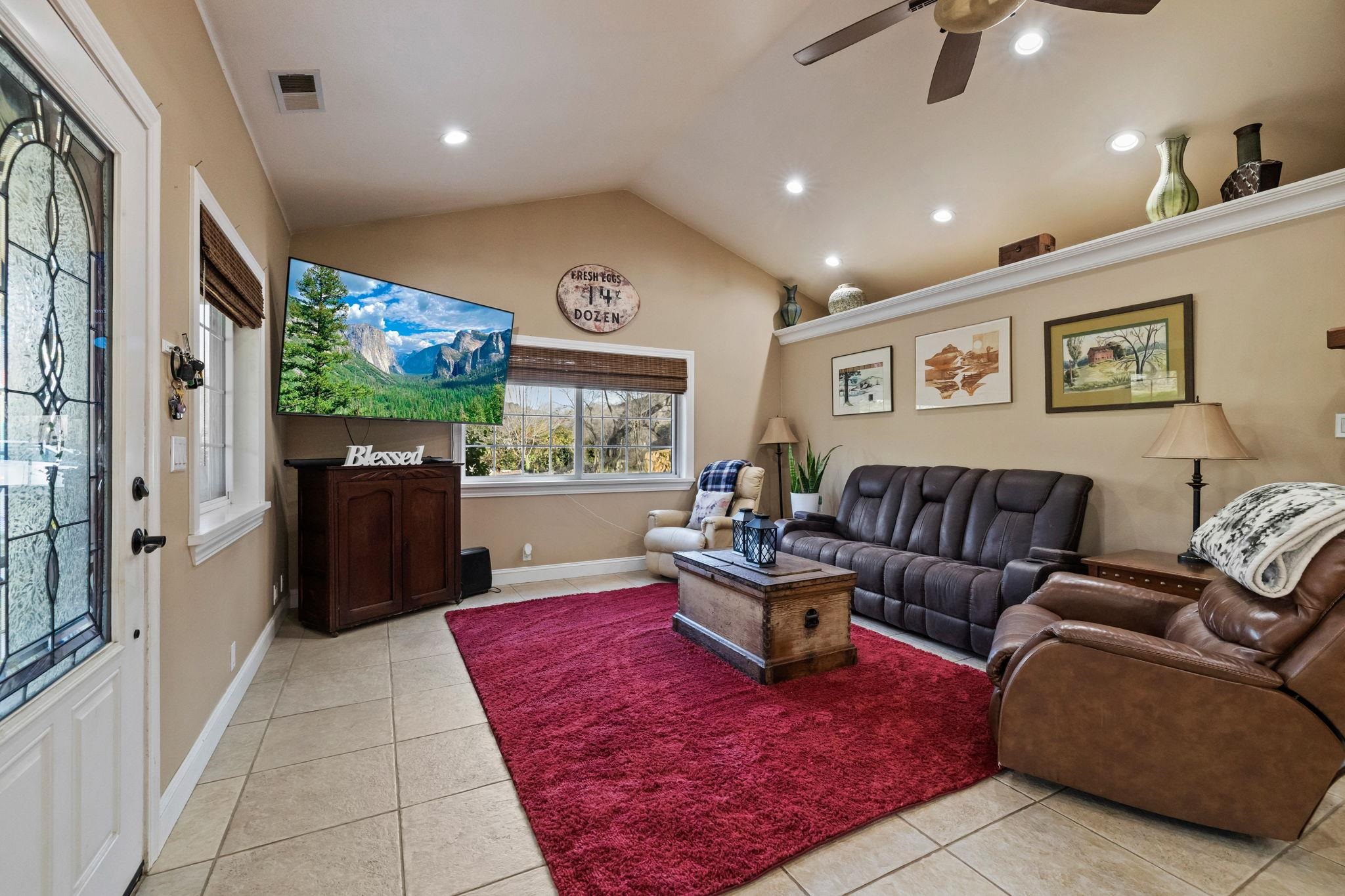 10177 Pulpit Rock Road Jamestown, CA 95327 - Photo 3 of 60 Living room with light tile patterned floors, vaulted ceiling, a ceiling fan, and recessed lighting